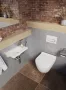 Ravak Uni Chrome RimOff fali kerámia WC csésze műanyag Soft-Close WC ülőkével, fehér kivitelben.